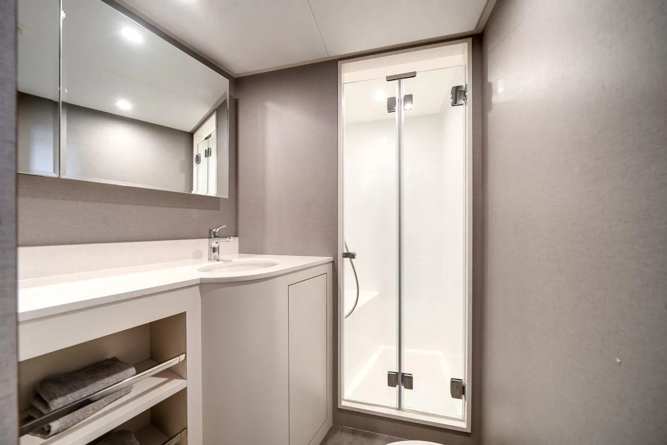 The yacht's bathroom features a sleek design with a modern shower and ample storage space. aboard OCEAN ALEXANDER 44G/01 Yacht for Sale
