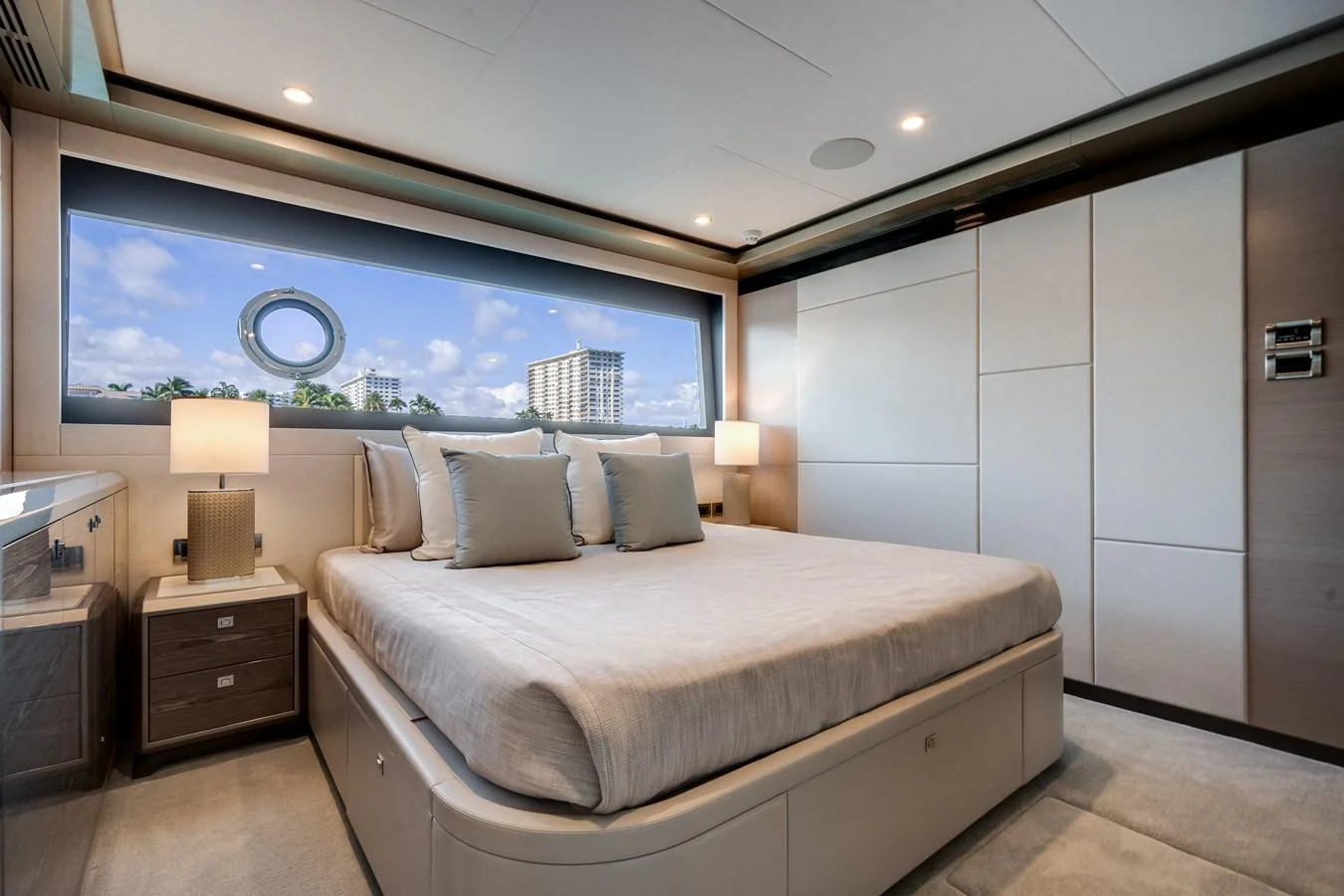 A luxurious stateroom featuring a large bed, modern furnishings, and a scenic window view. aboard OCEAN ALEXANDER 44G/01 Yacht for Sale