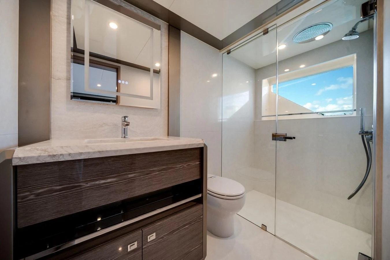The yacht's bathroom features a sleek design with a spacious shower and modern fixtures. aboard OCEAN ALEXANDER 44G/01 Yacht for Sale