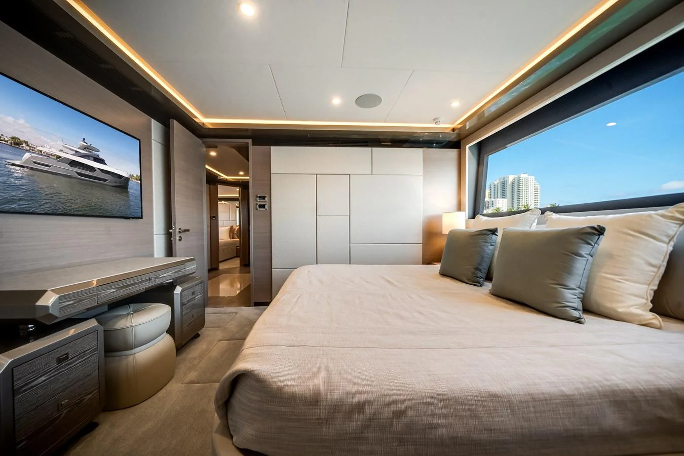 A luxurious stateroom with a large bed, modern decor, and a scenic view through the window. aboard OCEAN ALEXANDER 44G/01 Yacht for Sale