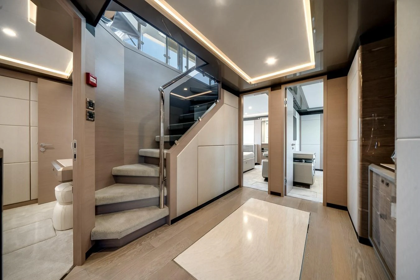 This image showcases the elegant interior of a yacht, featuring a staircase and modern design elements. aboard OCEAN ALEXANDER 44G/01 Yacht for Sale