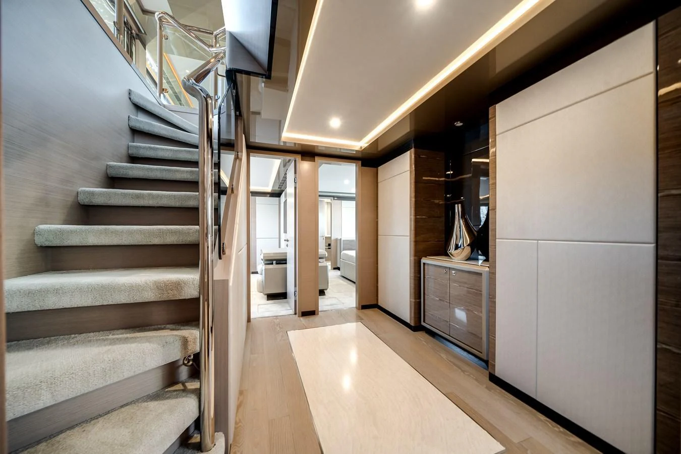 The yacht's interior features a modern hallway with elegant finishes and a staircase leading to the upper deck. aboard OCEAN ALEXANDER 44G/01 Yacht for Sale