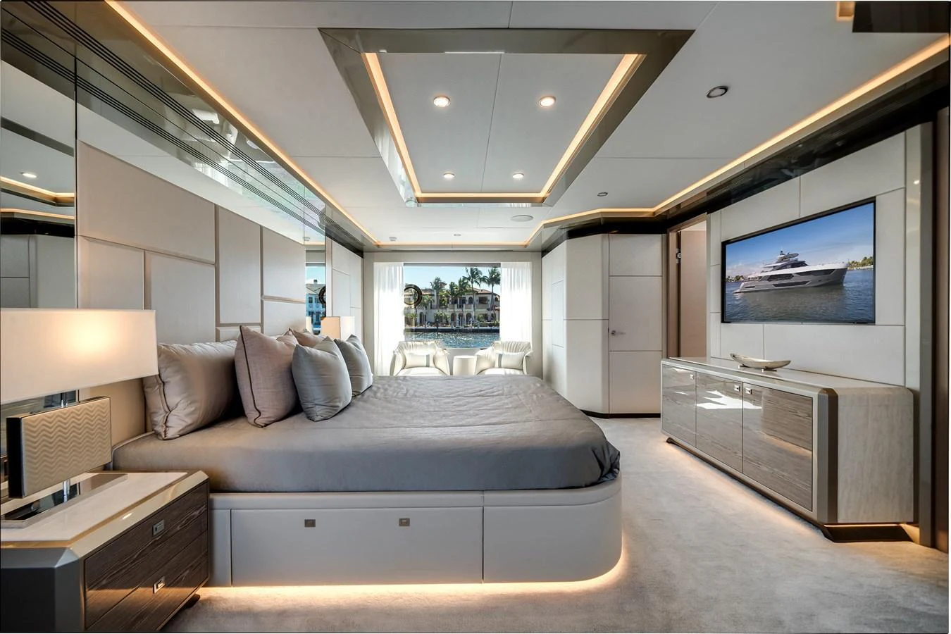 The master stateroom features a luxurious bed, modern decor, and a large window with a stunning view. aboard OCEAN ALEXANDER 44G/01 Yacht for Sale