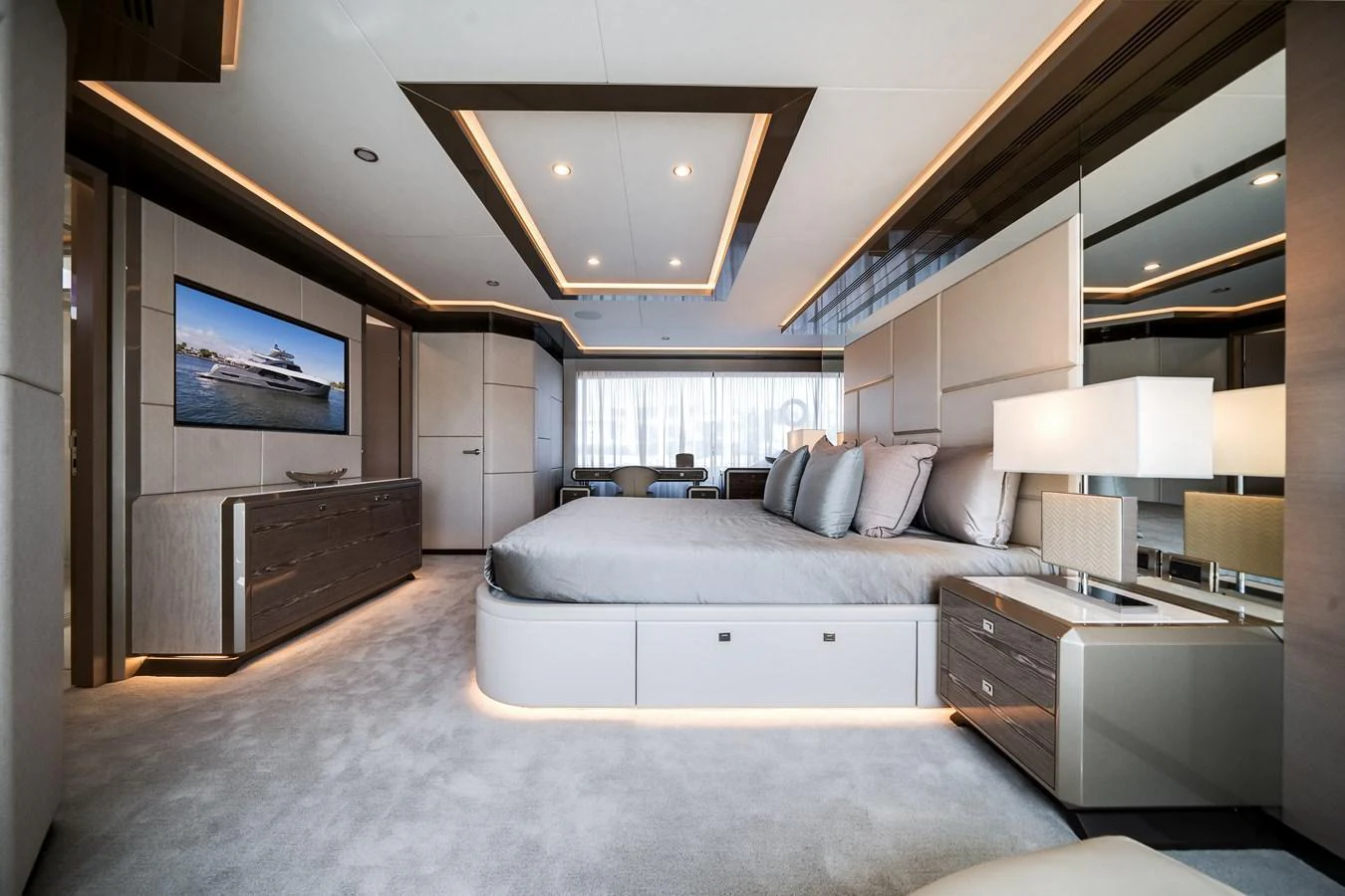 The master stateroom features a luxurious bed, modern furnishings, and ambient lighting. aboard OCEAN ALEXANDER 44G/01 Yacht for Sale