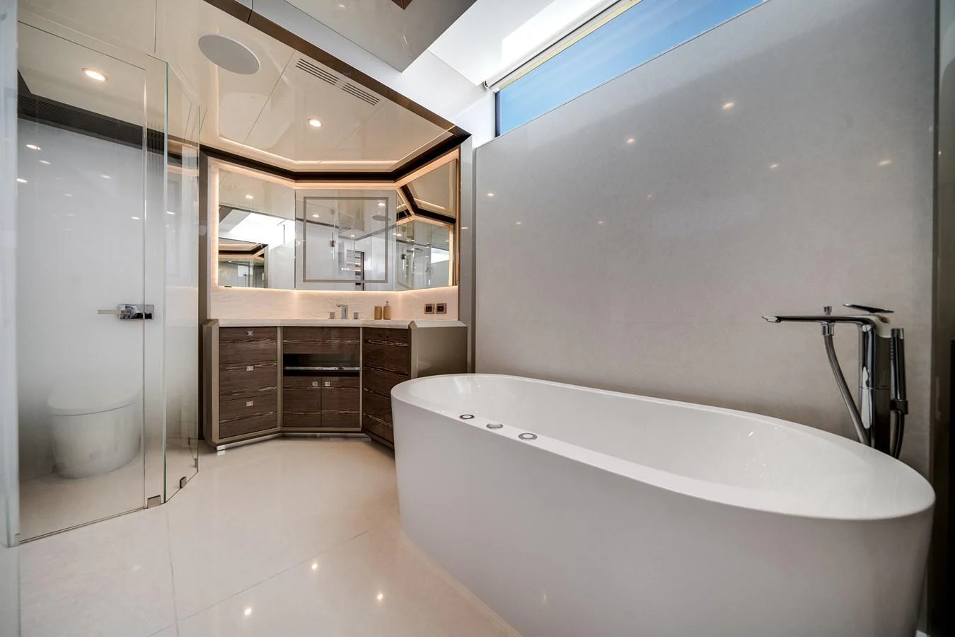 A luxurious yacht bathroom featuring a modern freestanding tub and sleek cabinetry. aboard OCEAN ALEXANDER 44G/01 Yacht for Sale