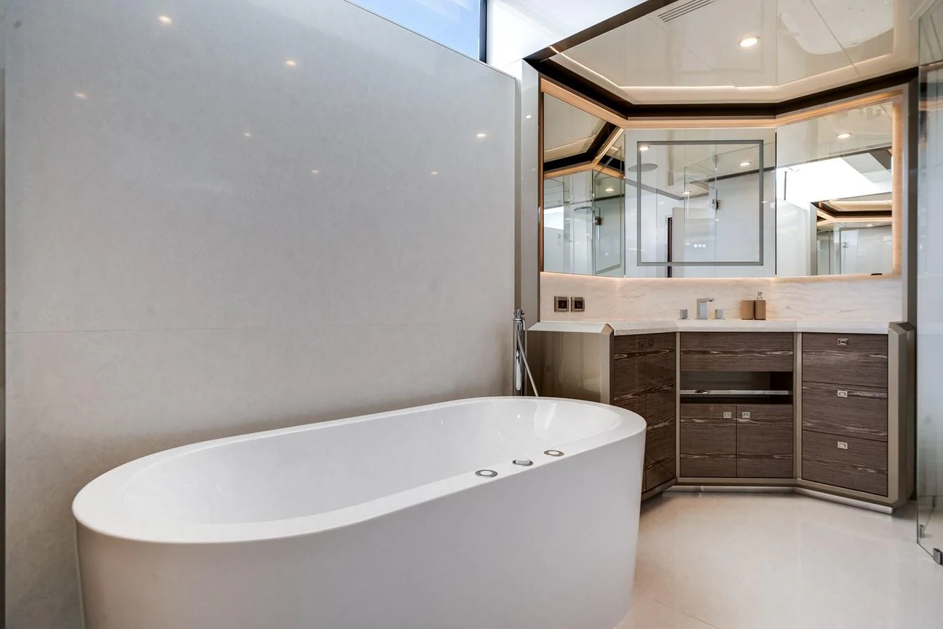 The yacht's bathroom features a sleek, modern design with a freestanding bathtub and elegant cabinetry. aboard OCEAN ALEXANDER 44G/01 Yacht for Sale