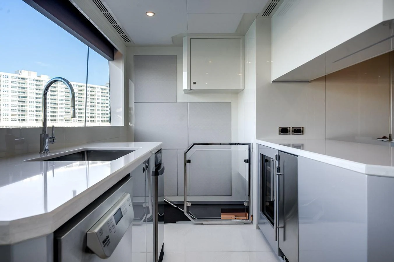 The yacht's galley features modern appliances and sleek, white cabinetry with ample counter space. aboard OCEAN ALEXANDER 44G/01 Yacht for Sale