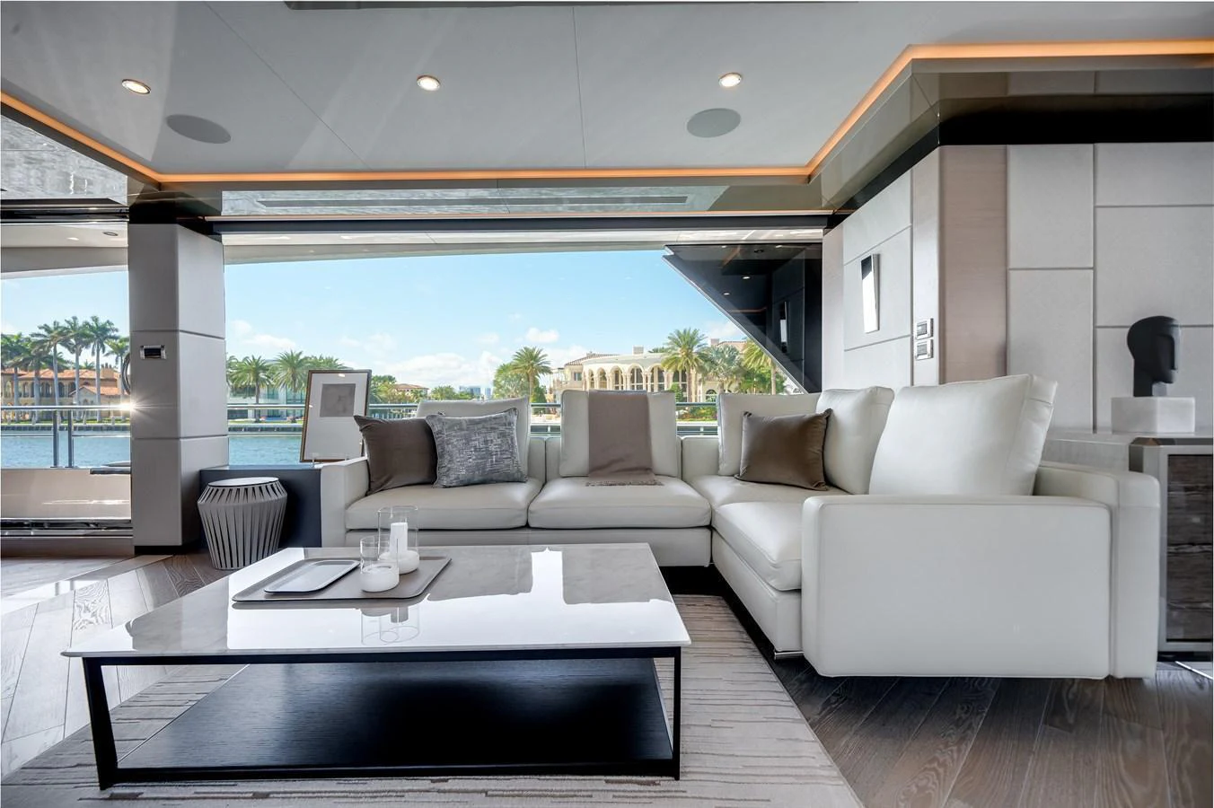 The salon features a luxurious seating area with a stunning view of the water through large windows. aboard OCEAN ALEXANDER 44G/01 Yacht for Sale
