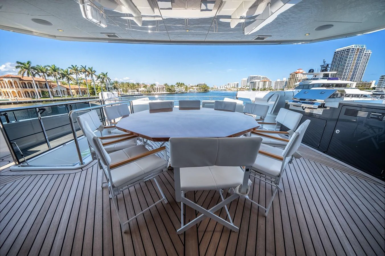 The aft deck features a spacious dining area with a large table and comfortable seating, perfect for alfresco meals with a view. aboard OCEAN ALEXANDER 44G/01 Yacht for Sale
