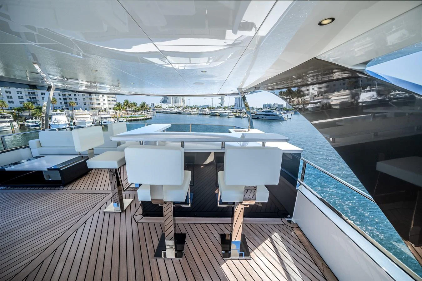 The flybridge offers a stylish and spacious area with modern seating and a stunning view of the marina. aboard OCEAN ALEXANDER 44G/01 Yacht for Sale
