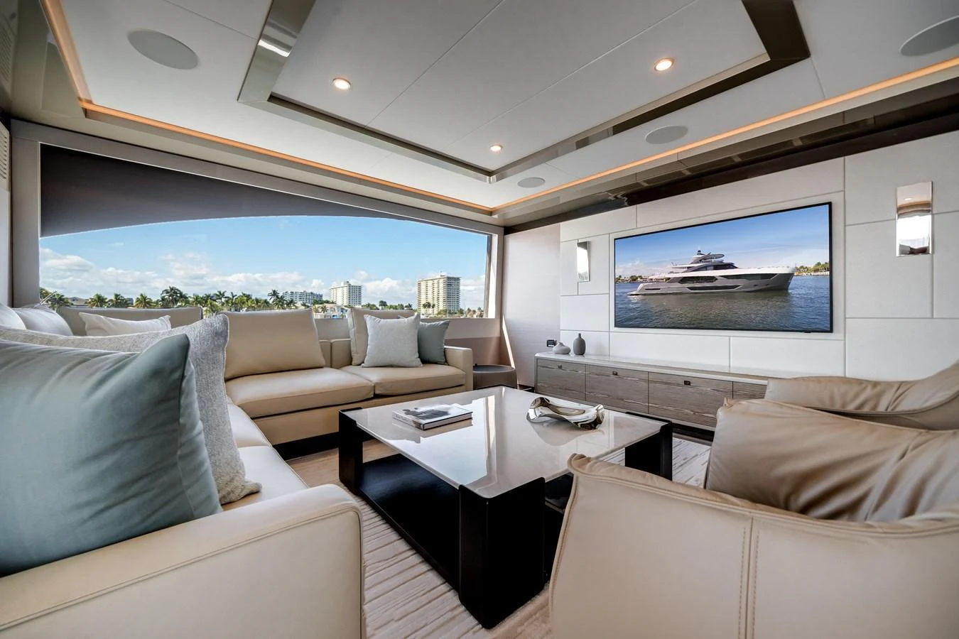 The salon offers a spacious and luxurious seating area with a large window providing stunning views. aboard OCEAN ALEXANDER 44G/01 Yacht for Sale