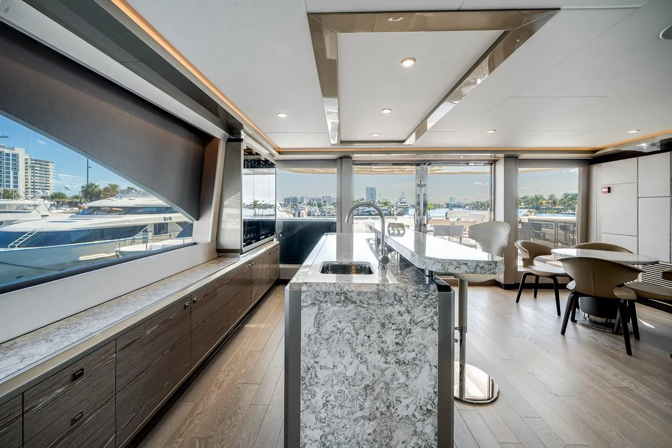 This image showcases a luxurious galley with modern appliances and elegant finishes, offering a stunning view of the marina. aboard OCEAN ALEXANDER 44G/01 Yacht for Sale