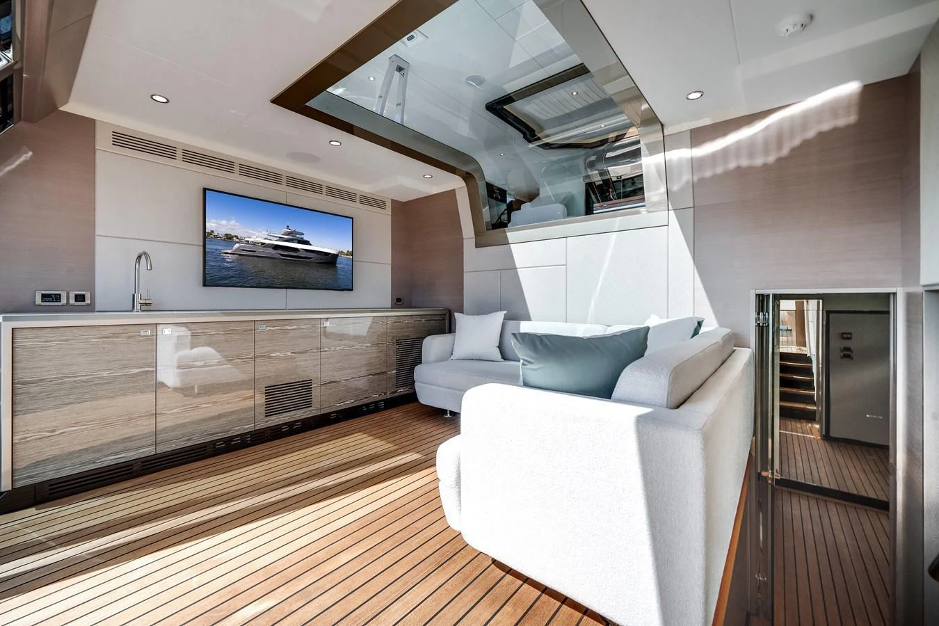 The salon features a comfortable seating area with a large TV and modern decor. aboard OCEAN ALEXANDER 44G/01 Yacht for Sale