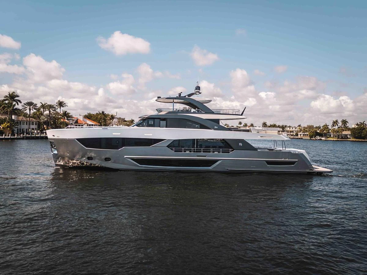 A sleek and modern yacht cruising on calm waters under a partly cloudy sky. aboard OCEAN ALEXANDER 44G/01 Yacht for Sale