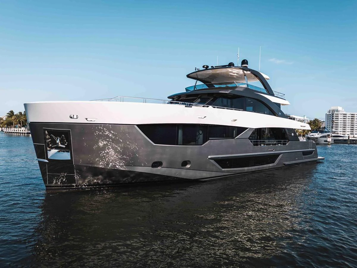 A sleek and modern yacht glides through calm waters under a clear blue sky. aboard OCEAN ALEXANDER 44G/01 Yacht for Sale