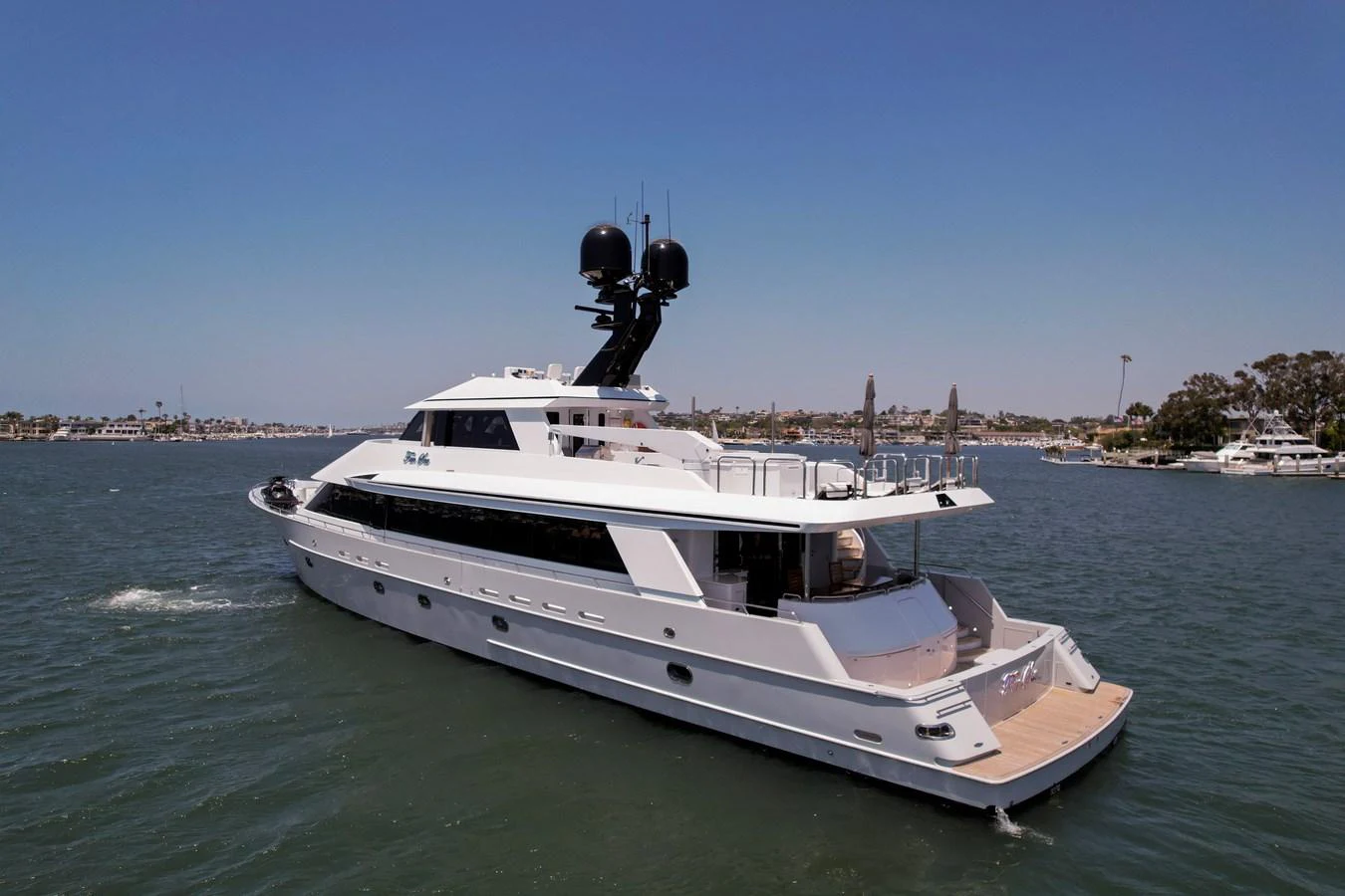 A sleek and modern yacht glides gracefully on calm waters under a clear blue sky. aboard GOLDEN BOY II Yacht for Sale
