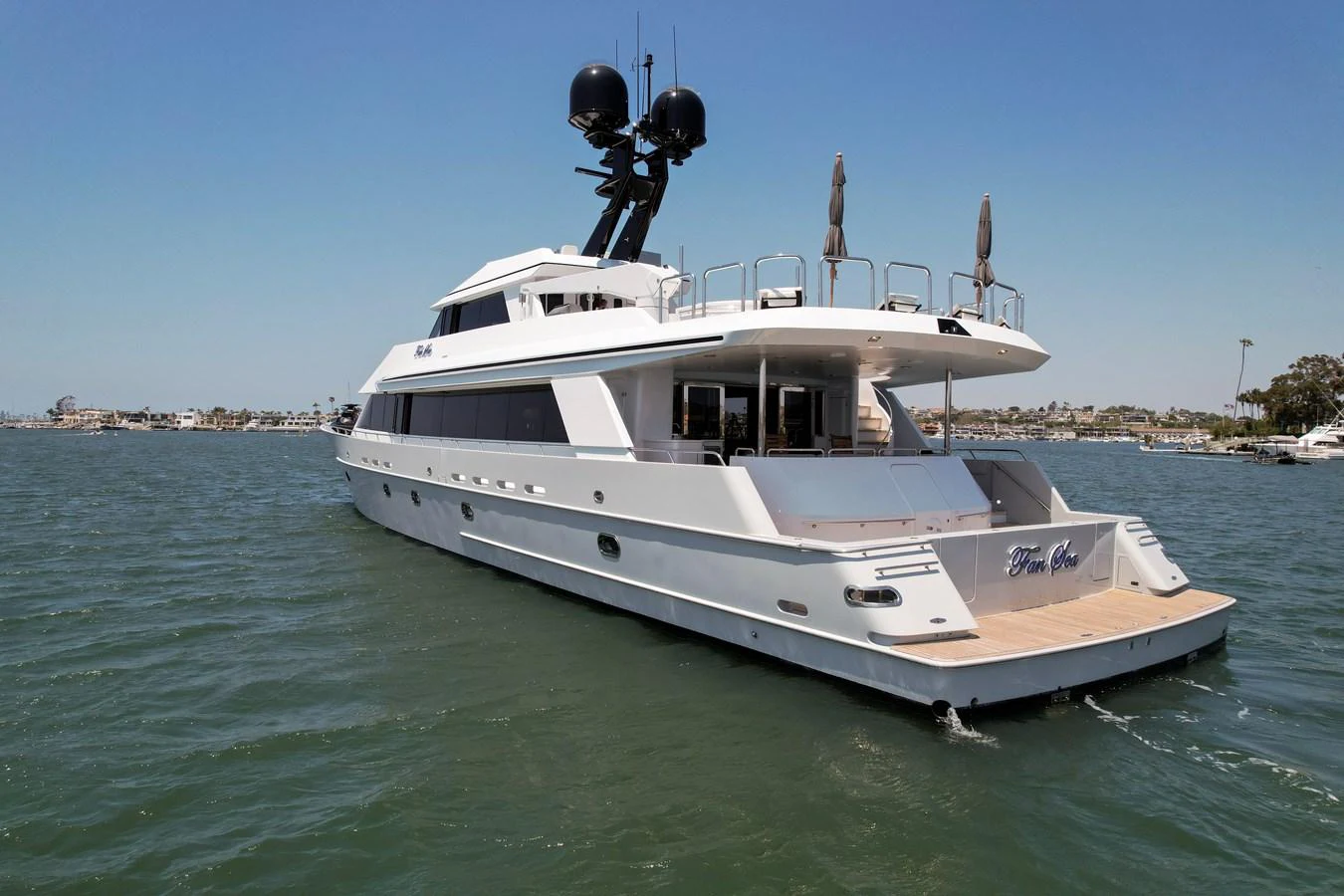 A sleek and modern yacht cruising on calm waters under a clear blue sky. aboard GOLDEN BOY II Yacht for Sale