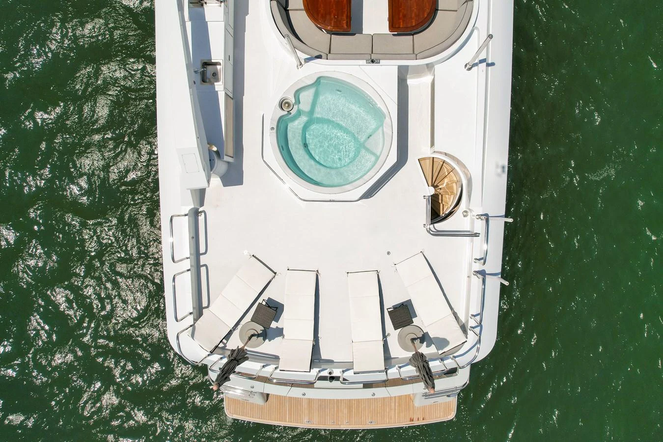 The aft deck features a luxurious jacuzzi surrounded by sun loungers, perfect for relaxation. aboard GOLDEN BOY II Yacht for Sale