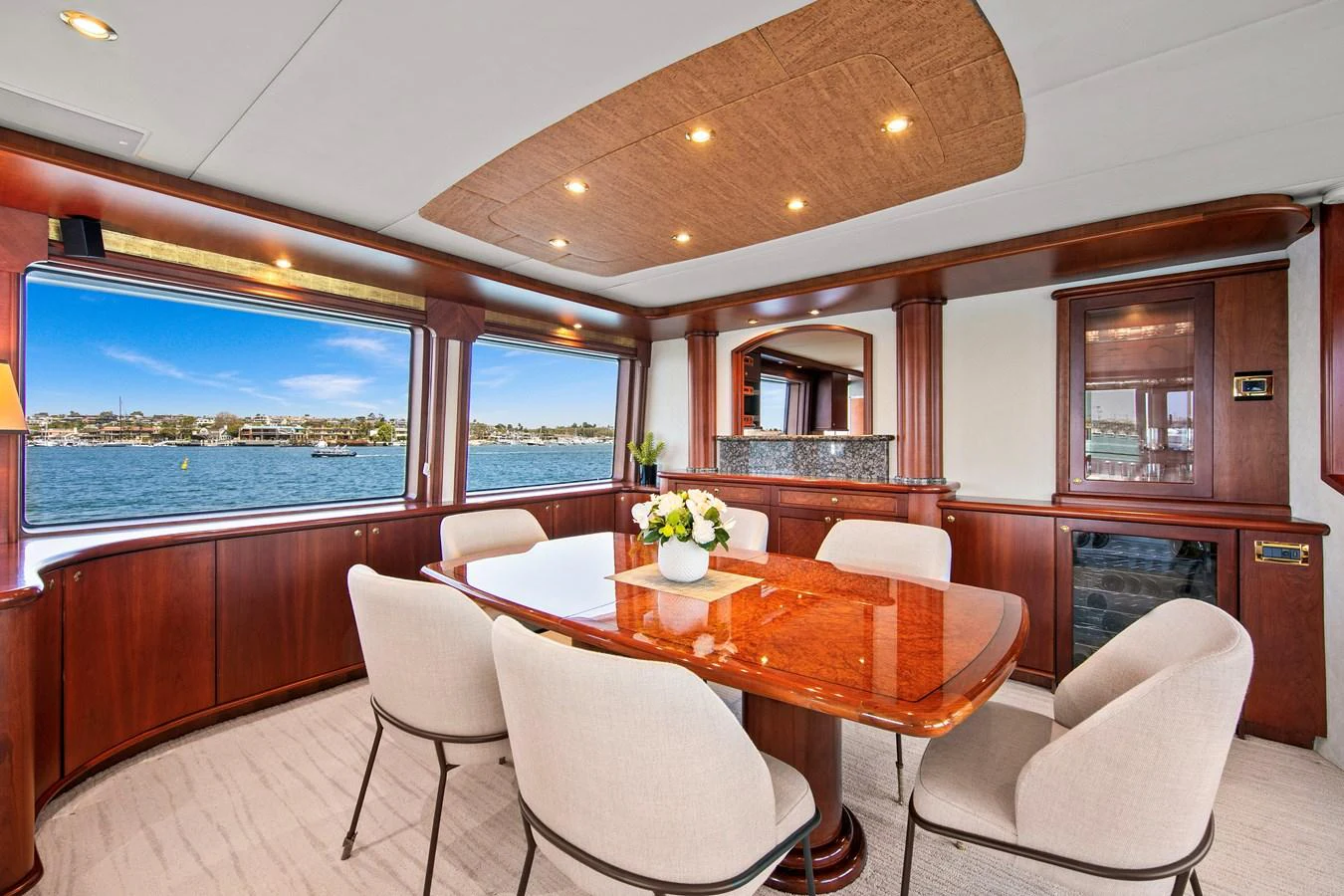 The yacht's dining area features elegant wood finishes and large windows offering stunning water views. aboard GOLDEN BOY II Yacht for Sale