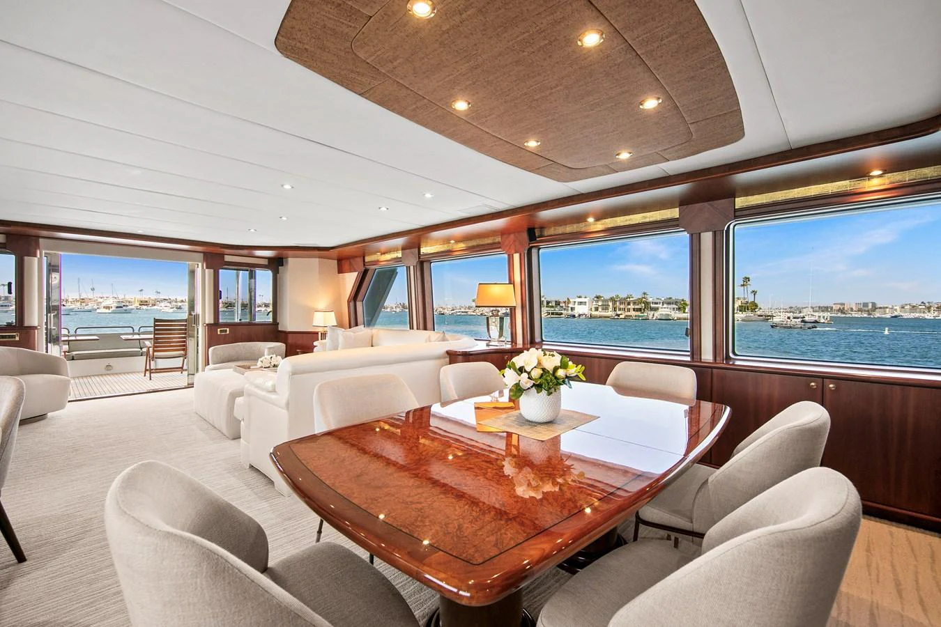 The spacious salon features elegant furnishings and large windows offering stunning views of the water. aboard GOLDEN BOY II Yacht for Sale