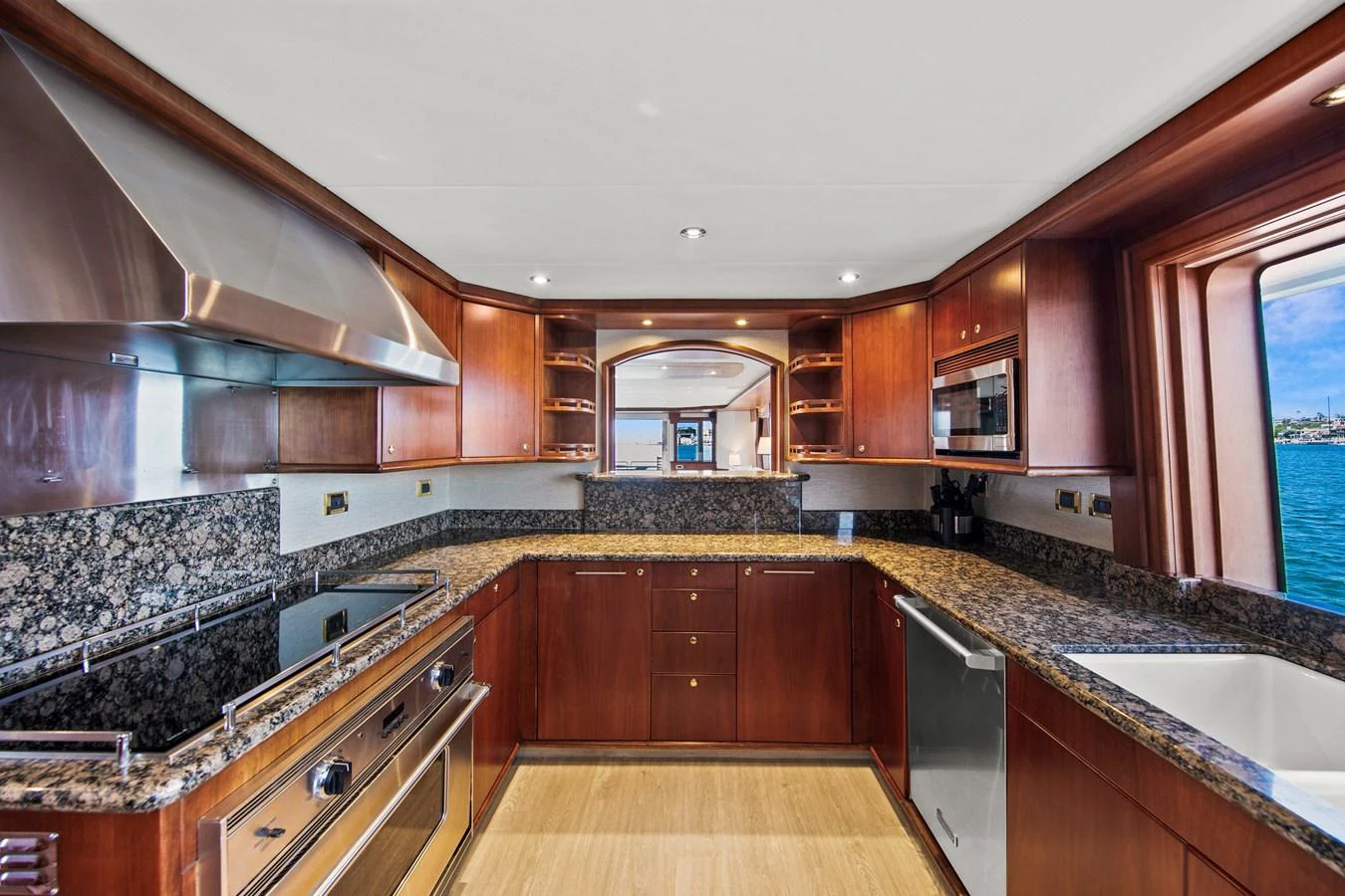 The yacht's galley features modern appliances and elegant wood cabinetry, offering a stylish and functional space for meal preparation. aboard GOLDEN BOY II Yacht for Sale