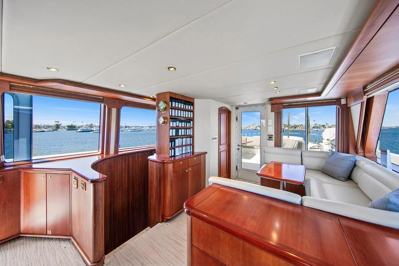 The yacht's salon features elegant wood finishes and large windows offering panoramic views. aboard GOLDEN BOY II Yacht for Sale