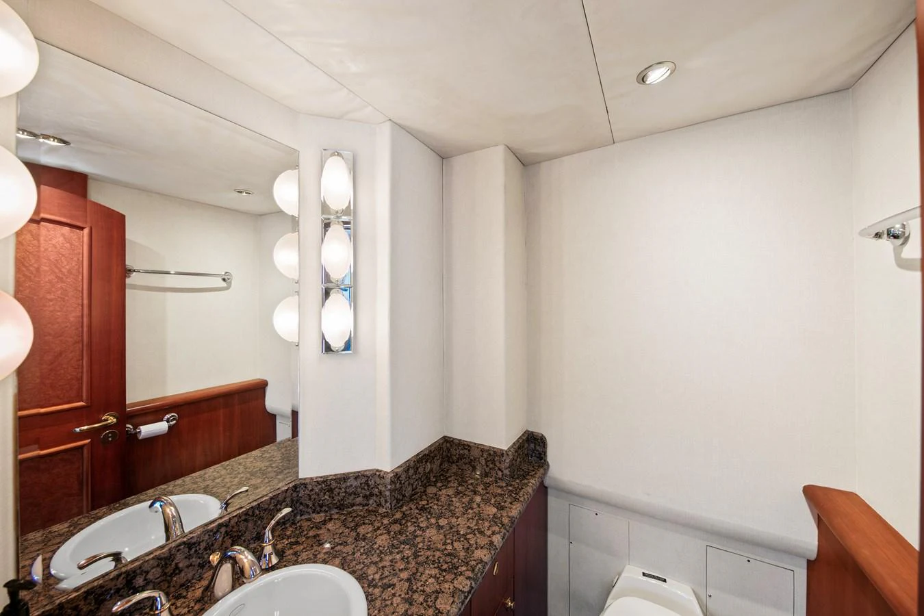 The yacht's bathroom features a sleek design with a granite countertop and modern fixtures. aboard GOLDEN BOY II Yacht for Sale
