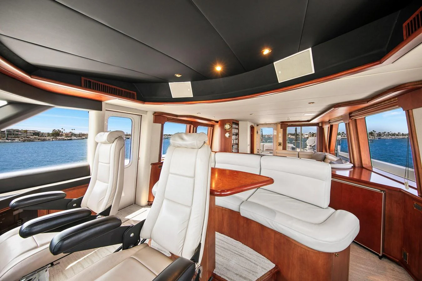 The helm area features luxurious seating and panoramic windows offering stunning views. aboard GOLDEN BOY II Yacht for Sale