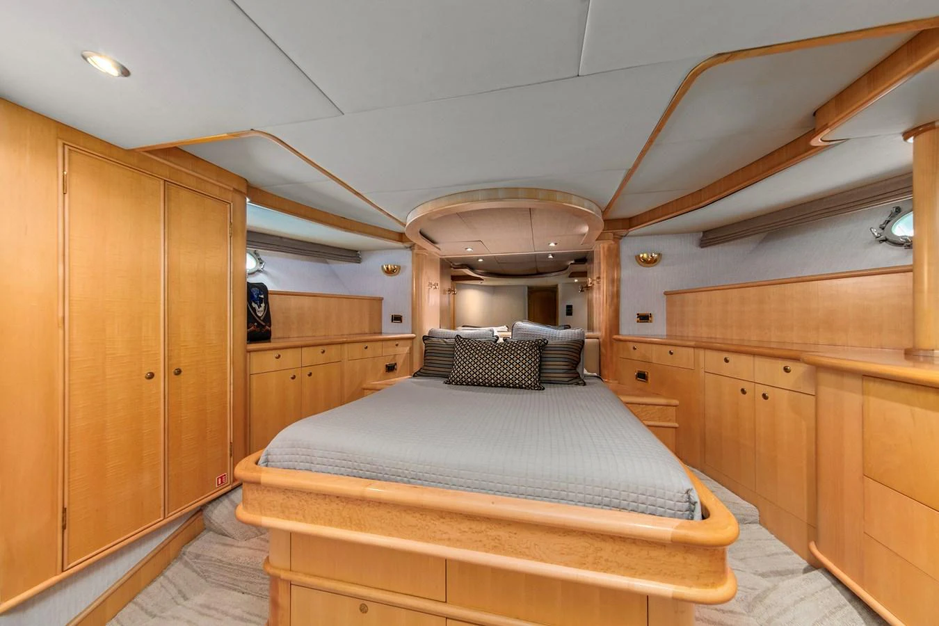 The stateroom features a spacious bed with elegant wooden cabinetry and soft lighting. aboard GOLDEN BOY II Yacht for Sale