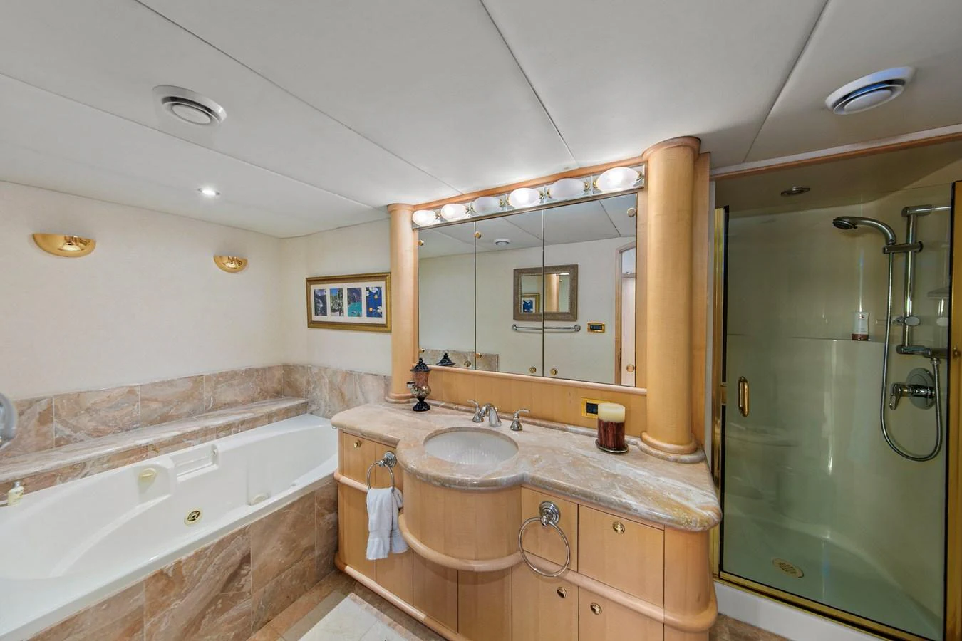 The yacht's bathroom features a luxurious bathtub, a spacious vanity, and a glass-enclosed shower. aboard GOLDEN BOY II Yacht for Sale