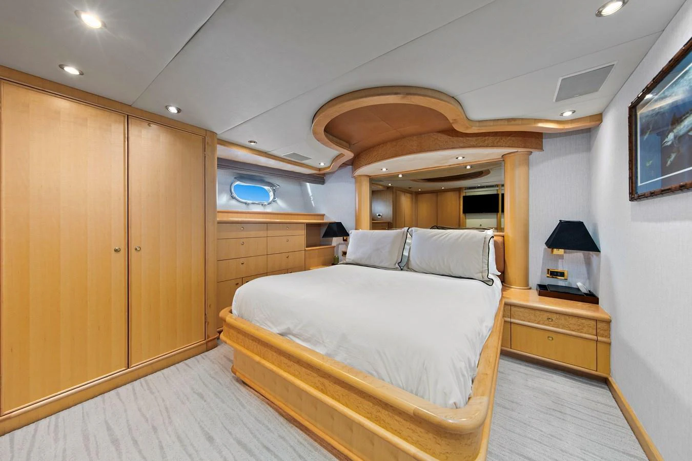 The master stateroom features a spacious bed with elegant wooden furnishings and soft lighting. aboard GOLDEN BOY II Yacht for Sale