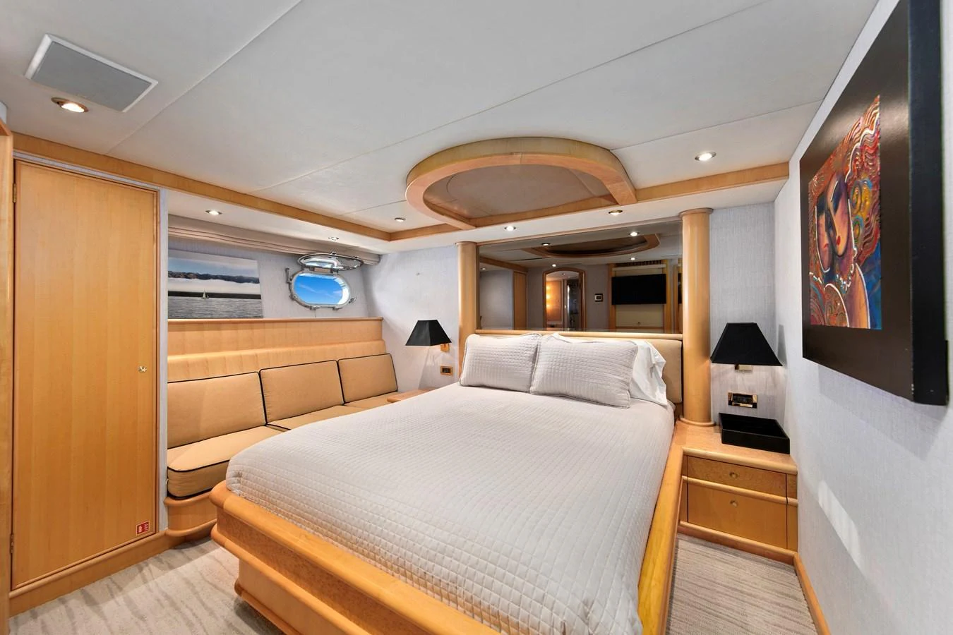 The master stateroom features a spacious bed, elegant wood finishes, and modern lighting. aboard GOLDEN BOY II Yacht for Sale