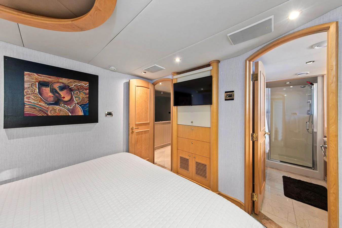 A luxurious stateroom featuring a comfortable bed, modern decor, and an ensuite bathroom. aboard GOLDEN BOY II Yacht for Sale