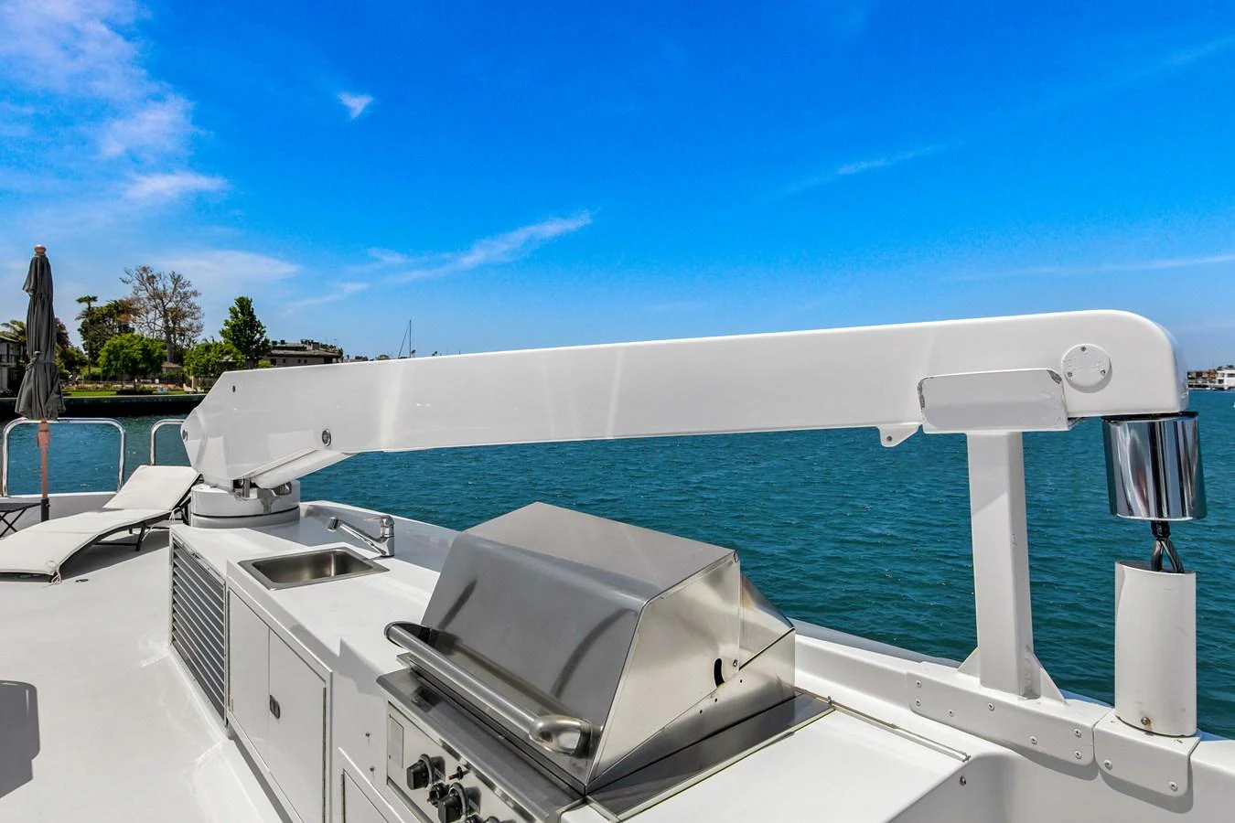 The sundeck features a sleek outdoor grill with a stunning view of the water. aboard GOLDEN BOY II Yacht for Sale