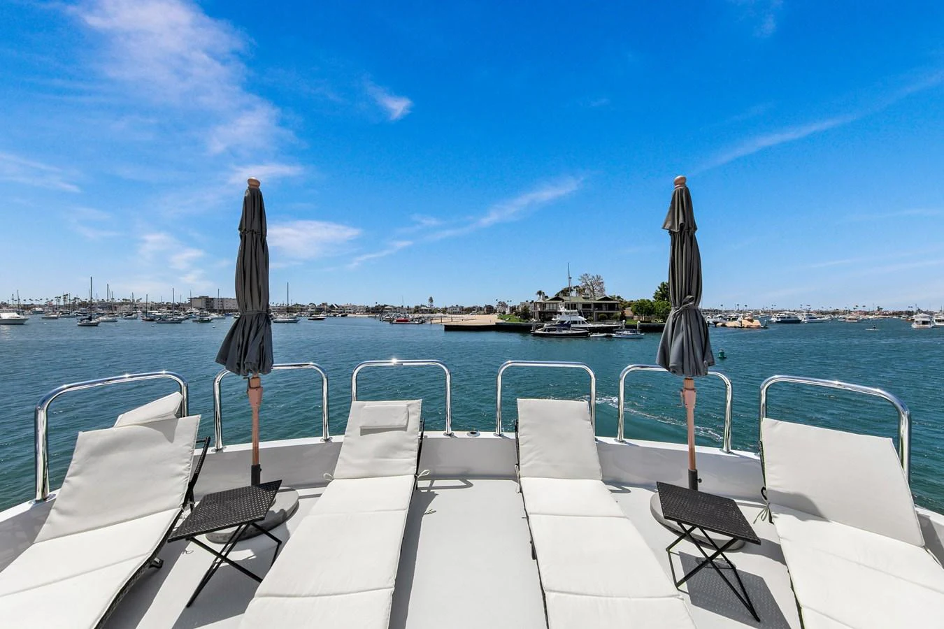 The sundeck offers a serene space with sun loungers and a stunning view of the water. aboard GOLDEN BOY II Yacht for Sale