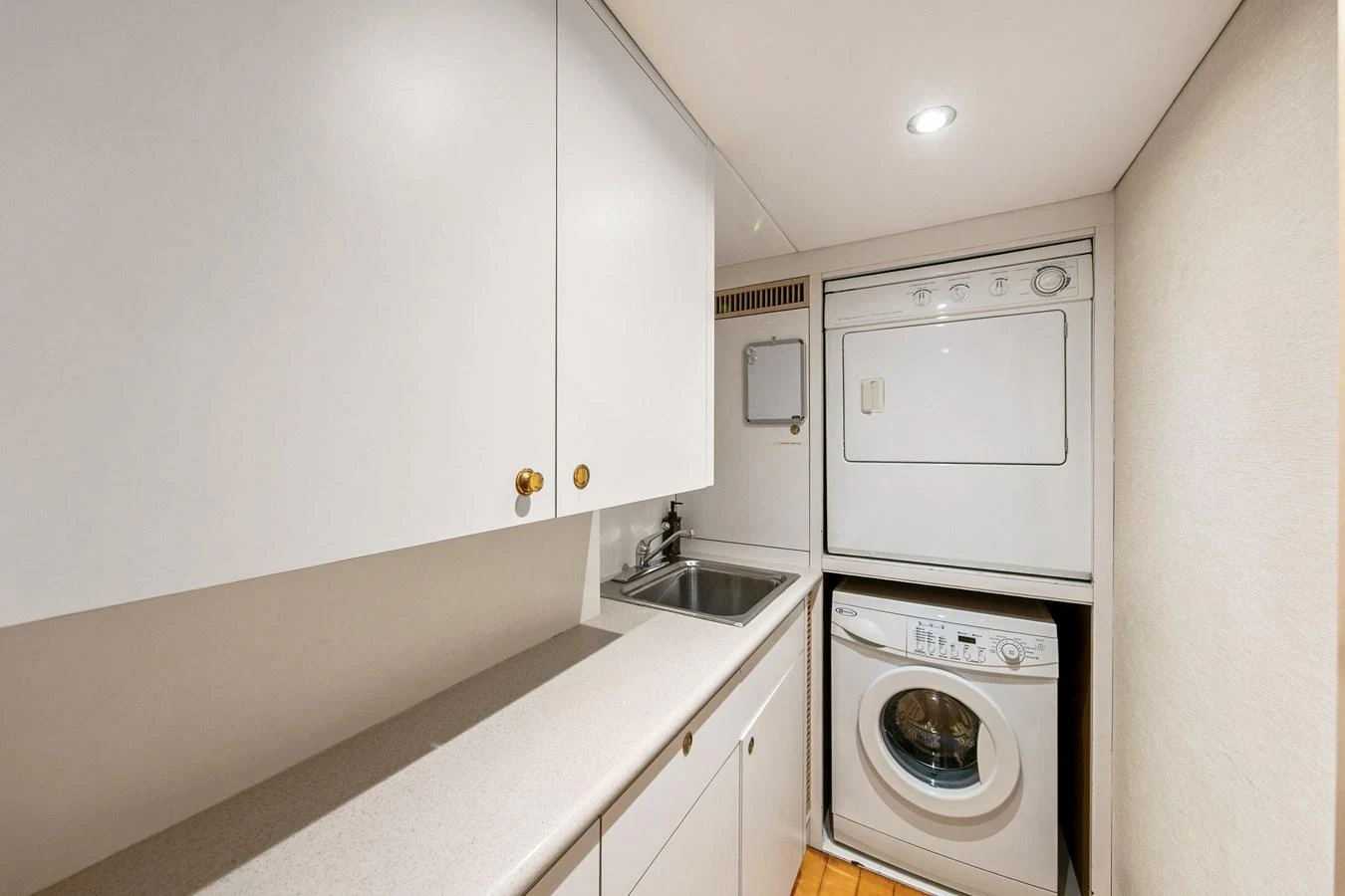 The yacht features a compact and functional laundry room with modern appliances. aboard GOLDEN BOY II Yacht for Sale