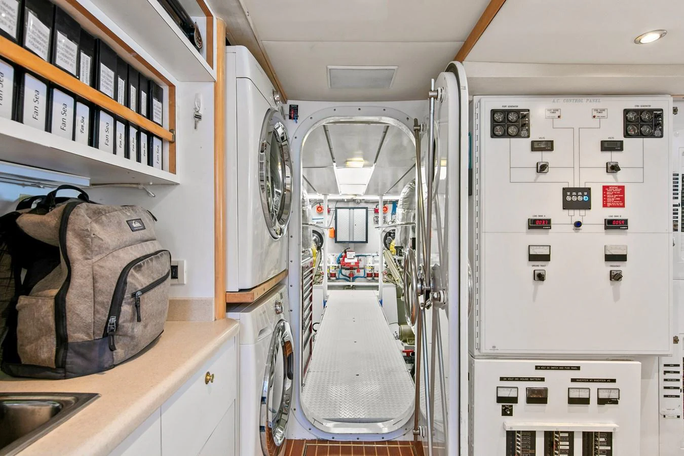 The image showcases a well-organized engine room with visible control panels and equipment. aboard GOLDEN BOY II Yacht for Sale