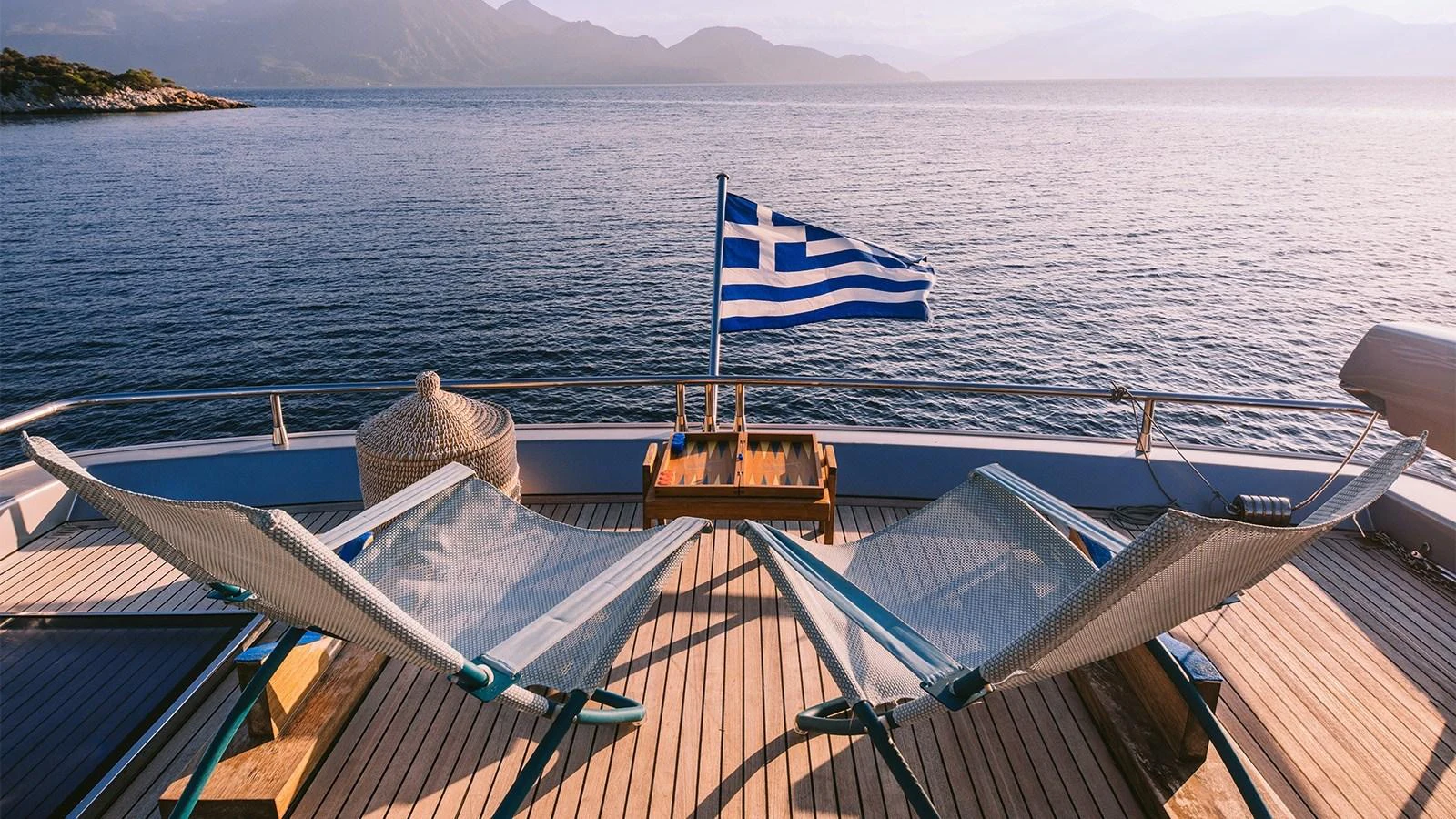 a boat with a flag on the front aboard ELVI Yacht for Sale