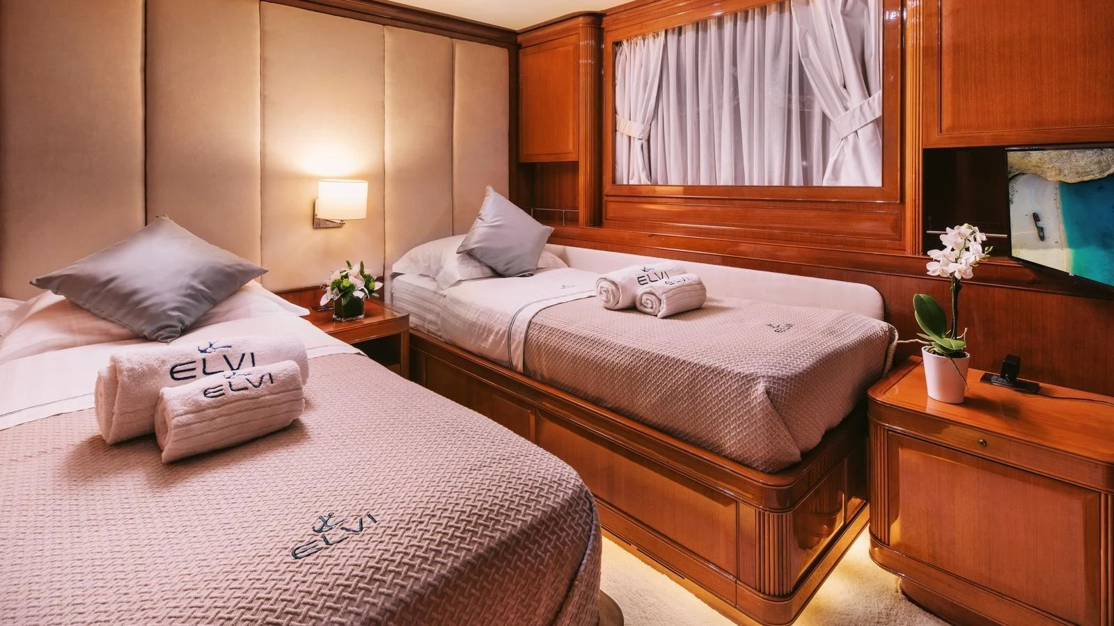 a hotel room with a bed and a desk aboard ELVI Yacht for Sale
