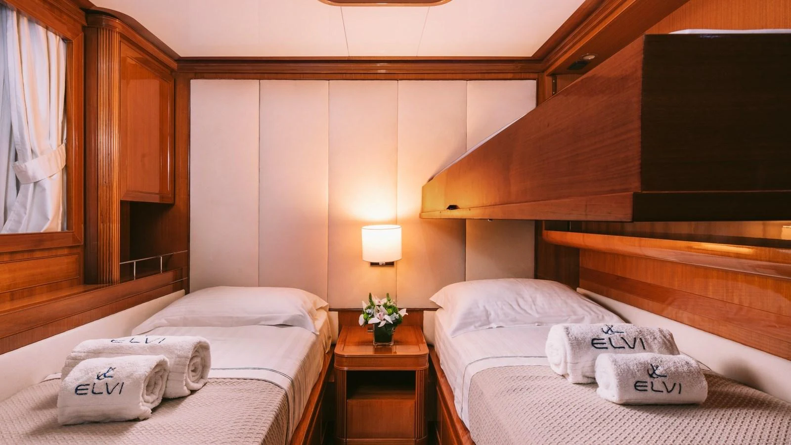 a room with beds and a table aboard ELVI Yacht for Sale