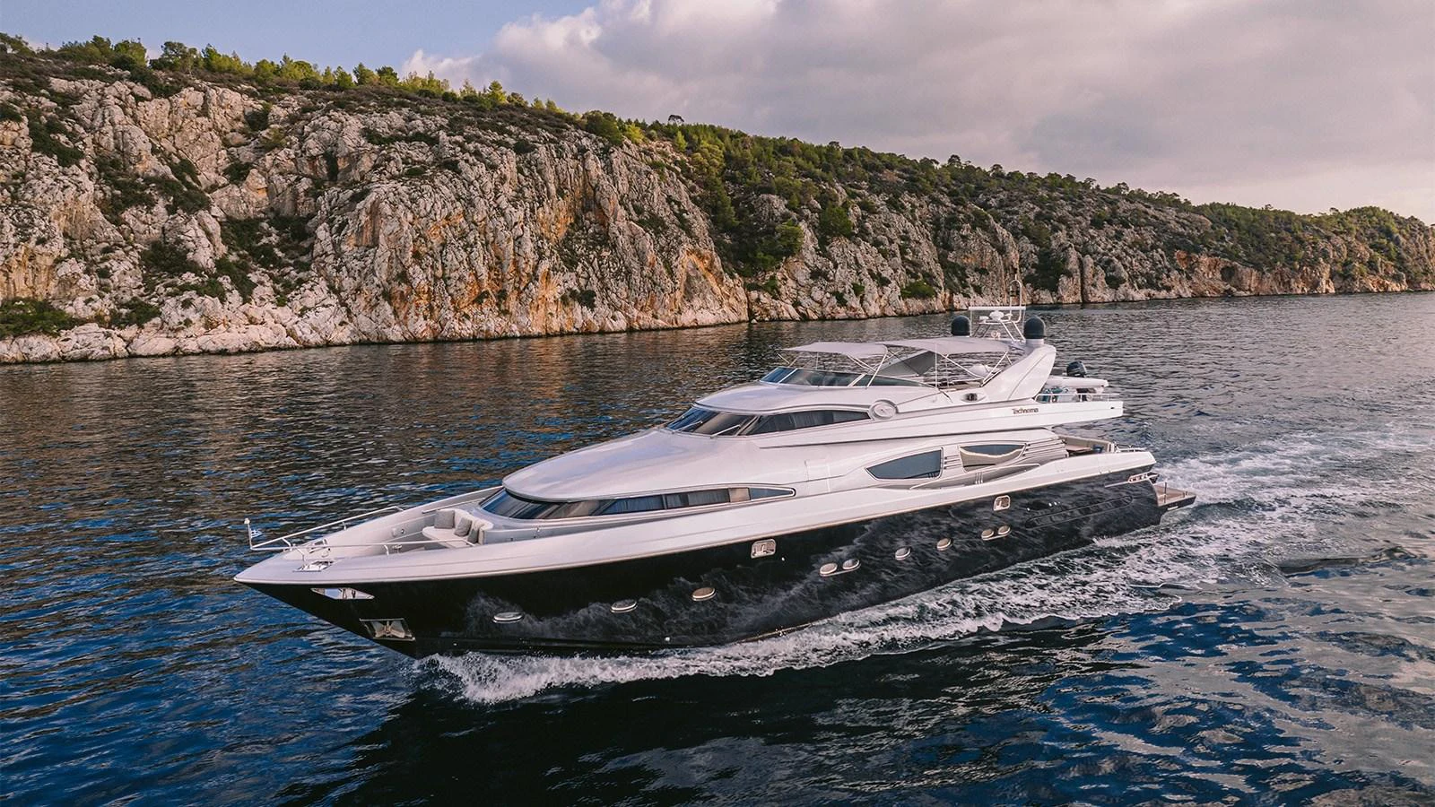 a white yacht on the water aboard ELVI Yacht for Sale