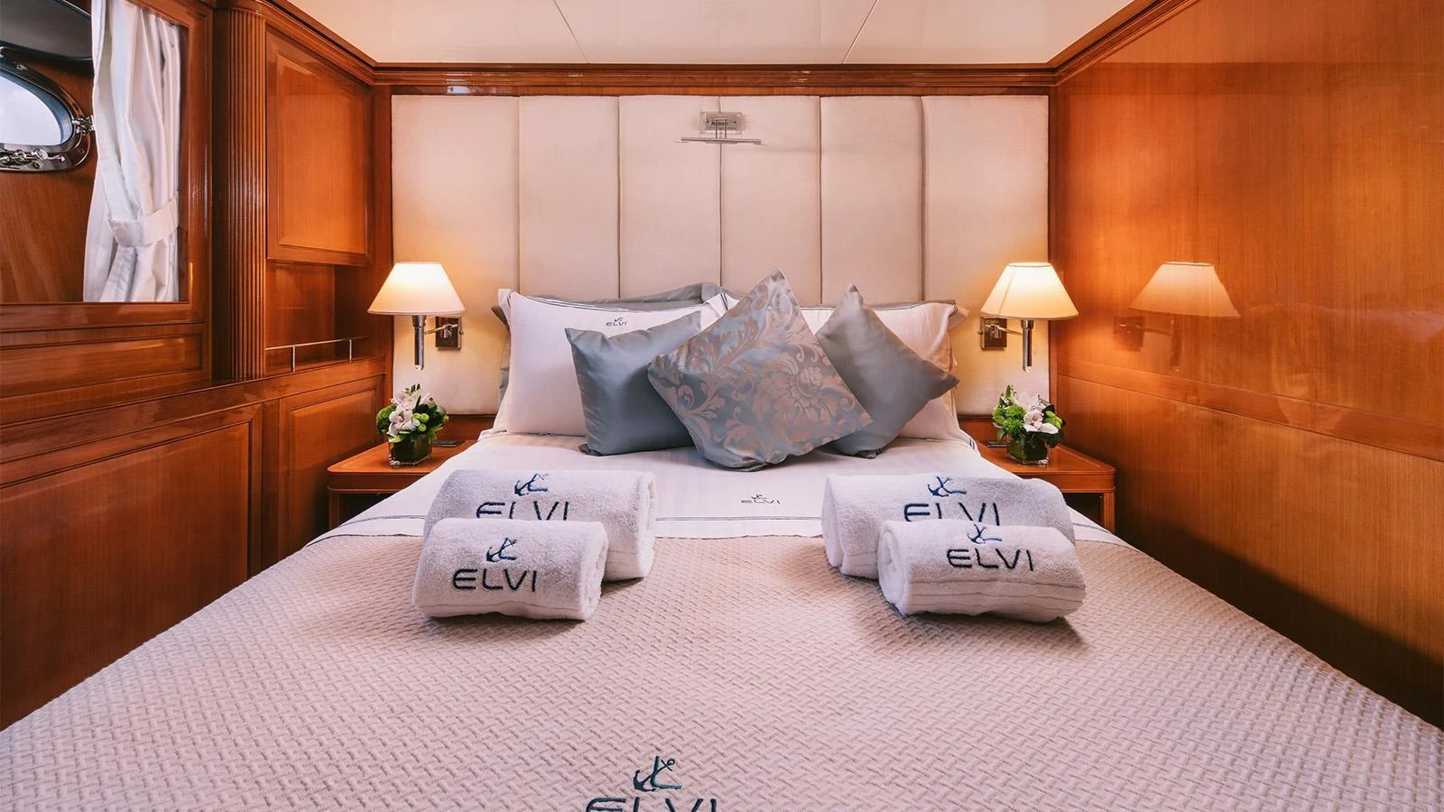 a bed with white pillows aboard ELVI Yacht for Sale