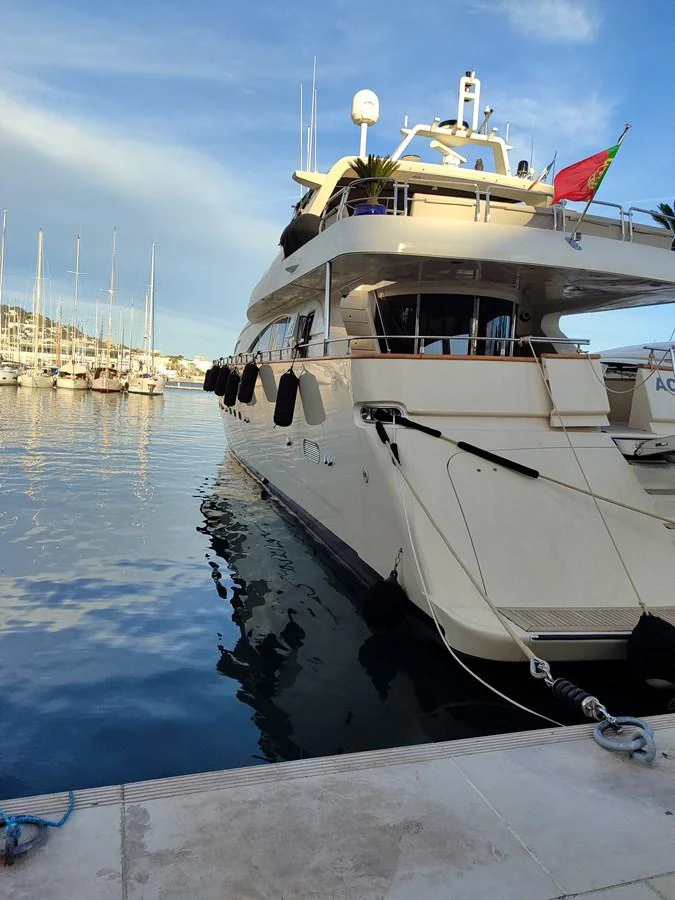 A luxurious yacht is docked at a serene marina, showcasing its elegant design and spacious decks. aboard ACCAMA DELTA Yacht for Sale