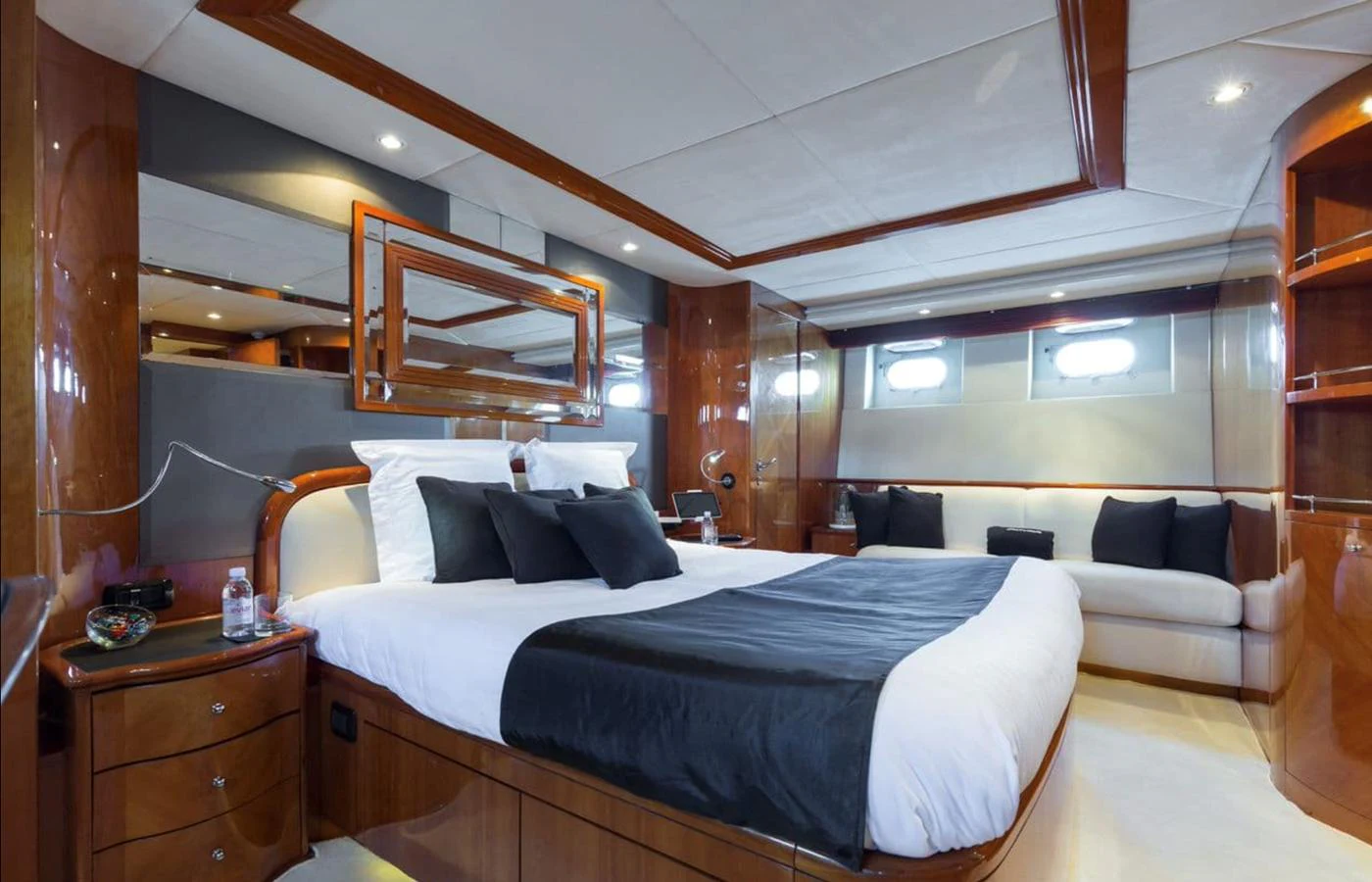 The master stateroom features a luxurious bed with elegant wood finishes and ample natural light. aboard ACCAMA DELTA Yacht for Sale