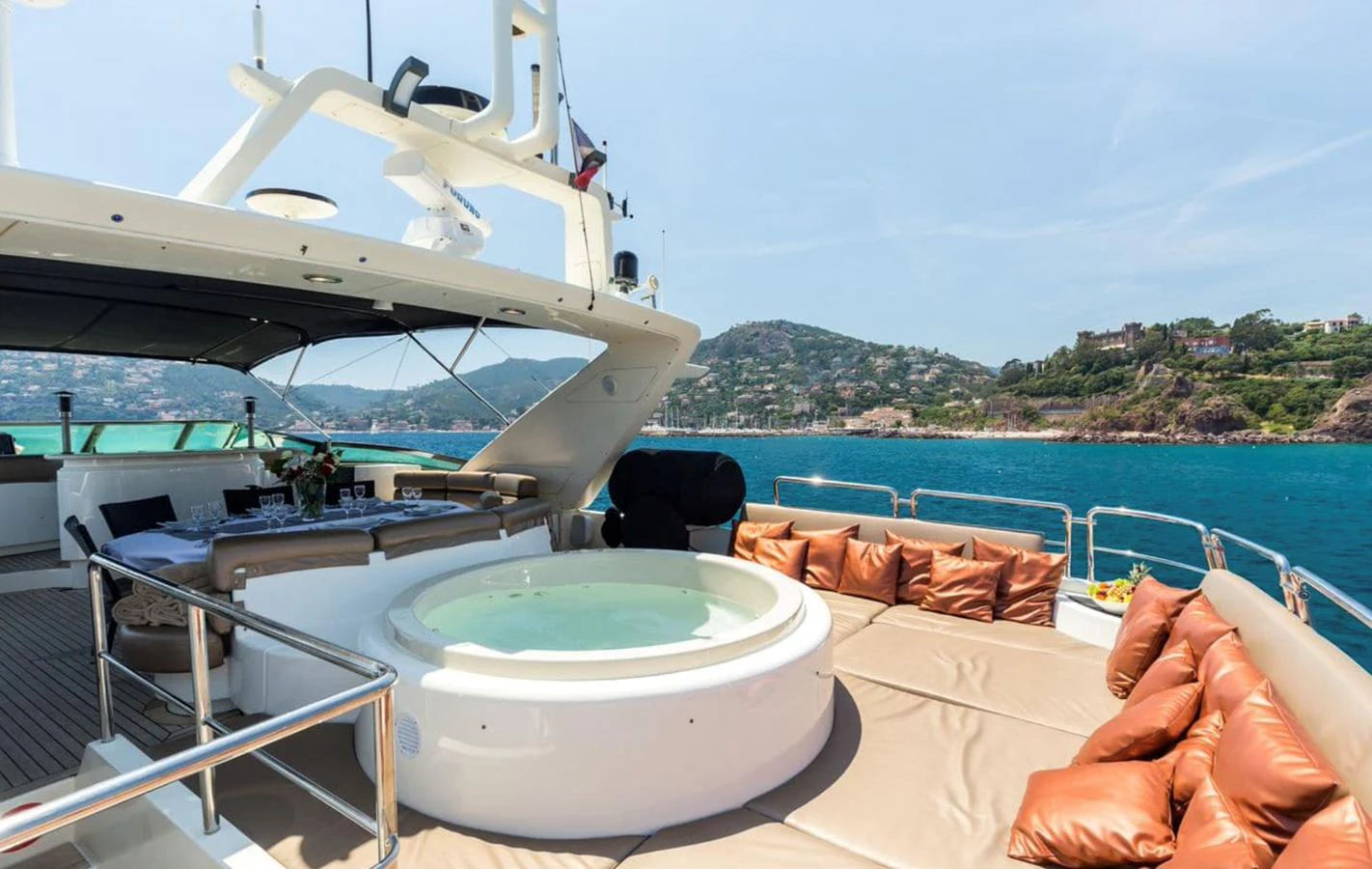 The yacht's sundeck features a luxurious jacuzzi and ample seating with stunning views of the coastline. aboard ACCAMA DELTA Yacht for Sale