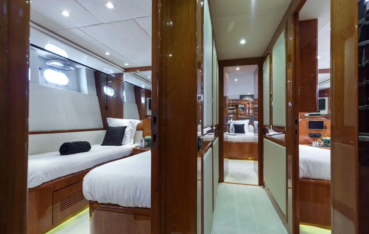 The guest stateroom features twin beds with luxurious bedding and elegant wood paneling. aboard ACCAMA DELTA Yacht for Sale