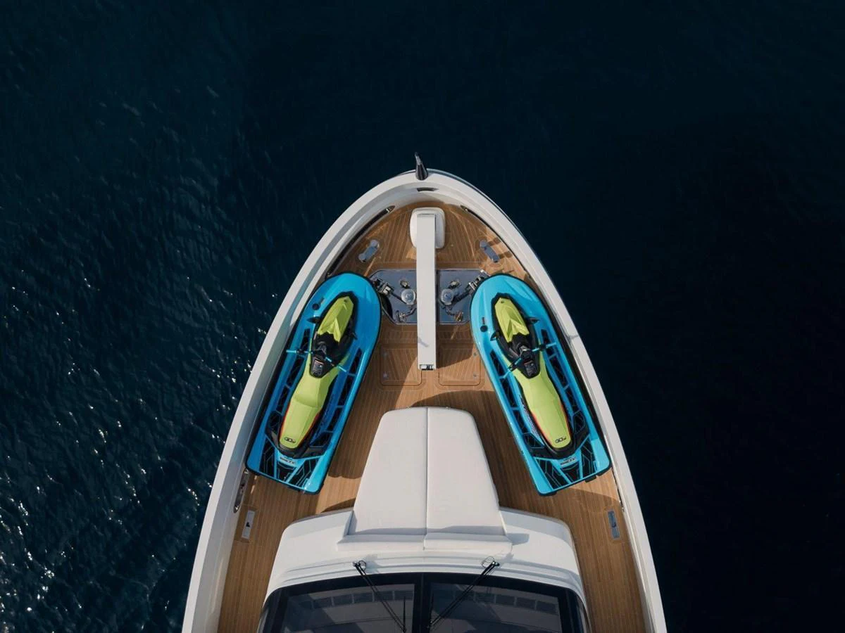 The bow of the yacht features two vibrant kayaks secured on the deck, ready for adventure. aboard MINI Yacht for Sale