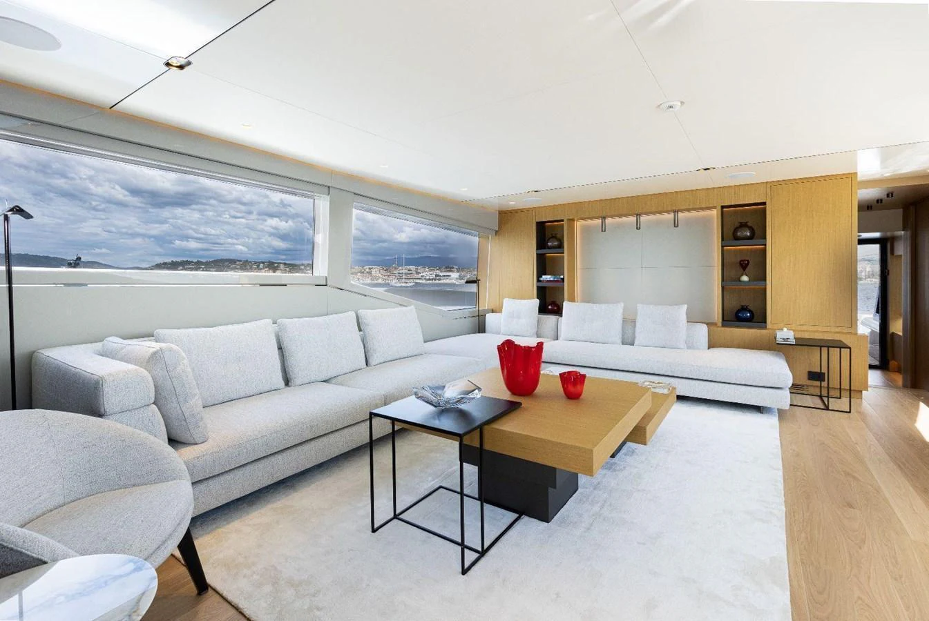 The salon features a spacious and modern design with ample seating and large windows offering stunning views. aboard MINI Yacht for Sale