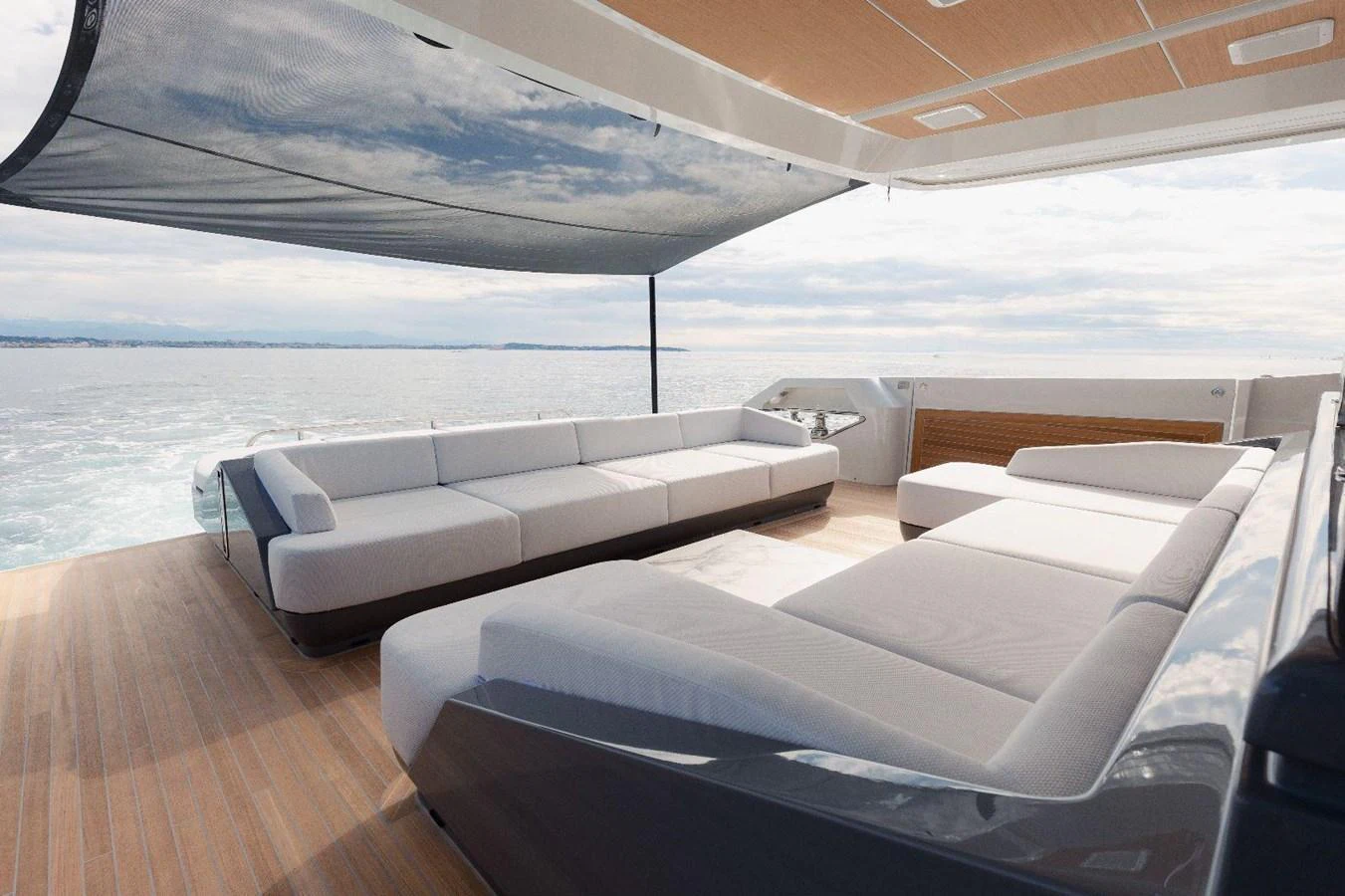 The aft deck features spacious, comfortable seating with a stylish canopy overhead. aboard MINI Yacht for Sale
