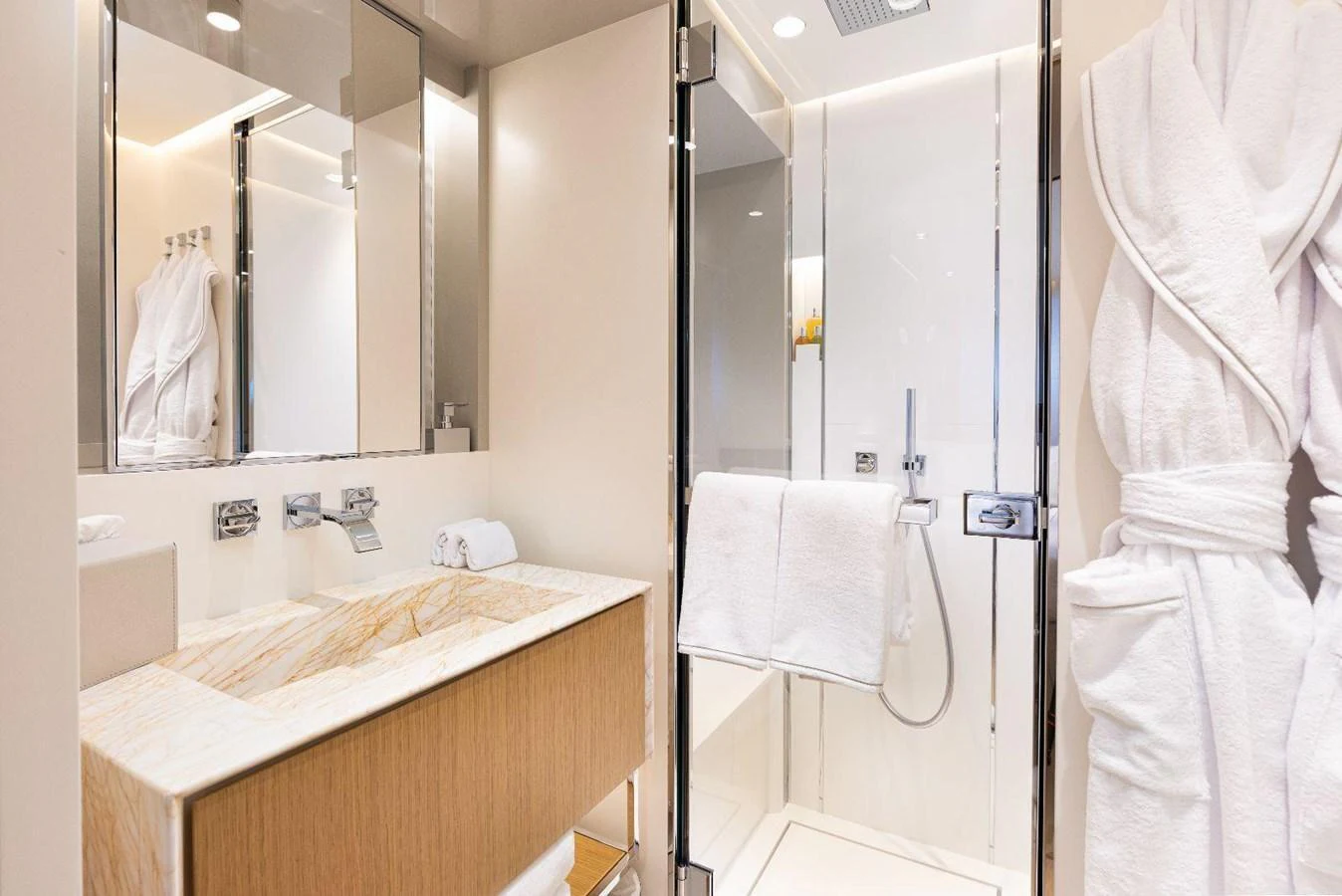 The yacht's bathroom features a sleek and modern design with luxurious amenities. aboard MINI Yacht for Sale